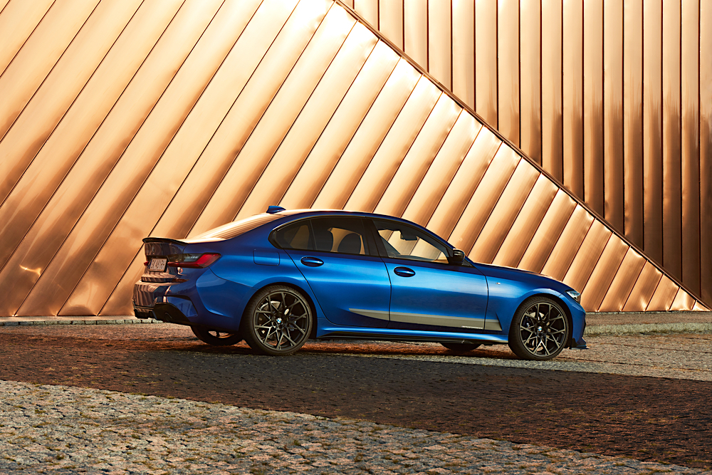 BMW 3 Series In Front of Gold Colored Building