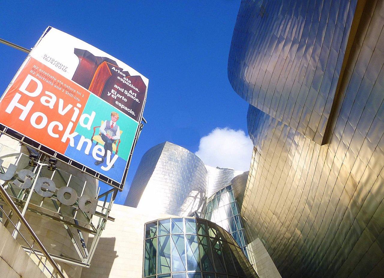 Bilbao Guggenheim Museum exterior with David Hockney exhibit billboard displayed